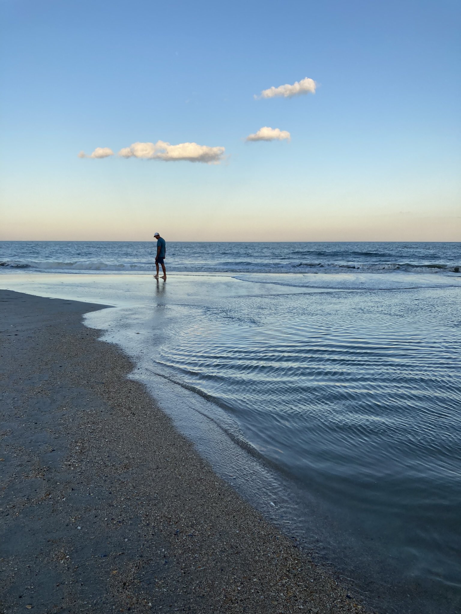 image of person walking on beach